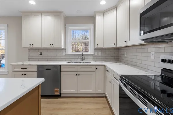 a kitchen with a sink stove and cabinets