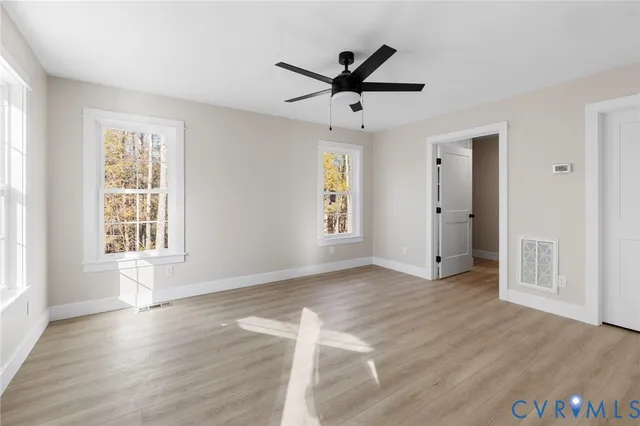 a view of a livingroom with a ceiling fan and window