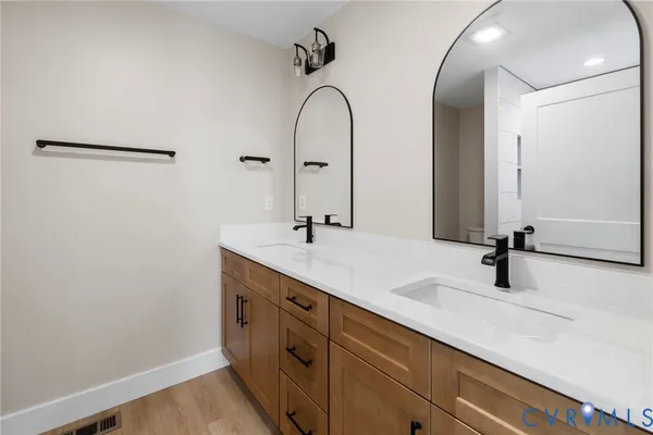 a bathroom with a double vanity sink and a mirror