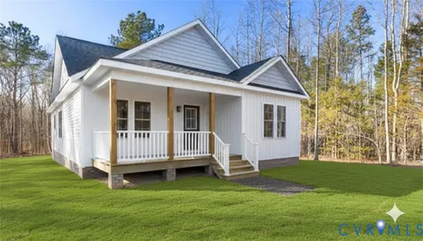 a view of a house with a yard and deck