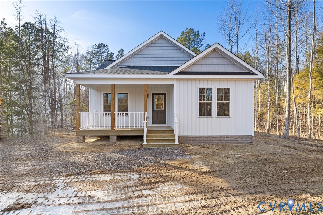 320 Vogel Road Cumberland, VA 23040 - Photo 4 of 28 a white house that has a small yard and a large window