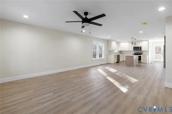 a view of a kitchen with a stove cabinets and wooden floor
