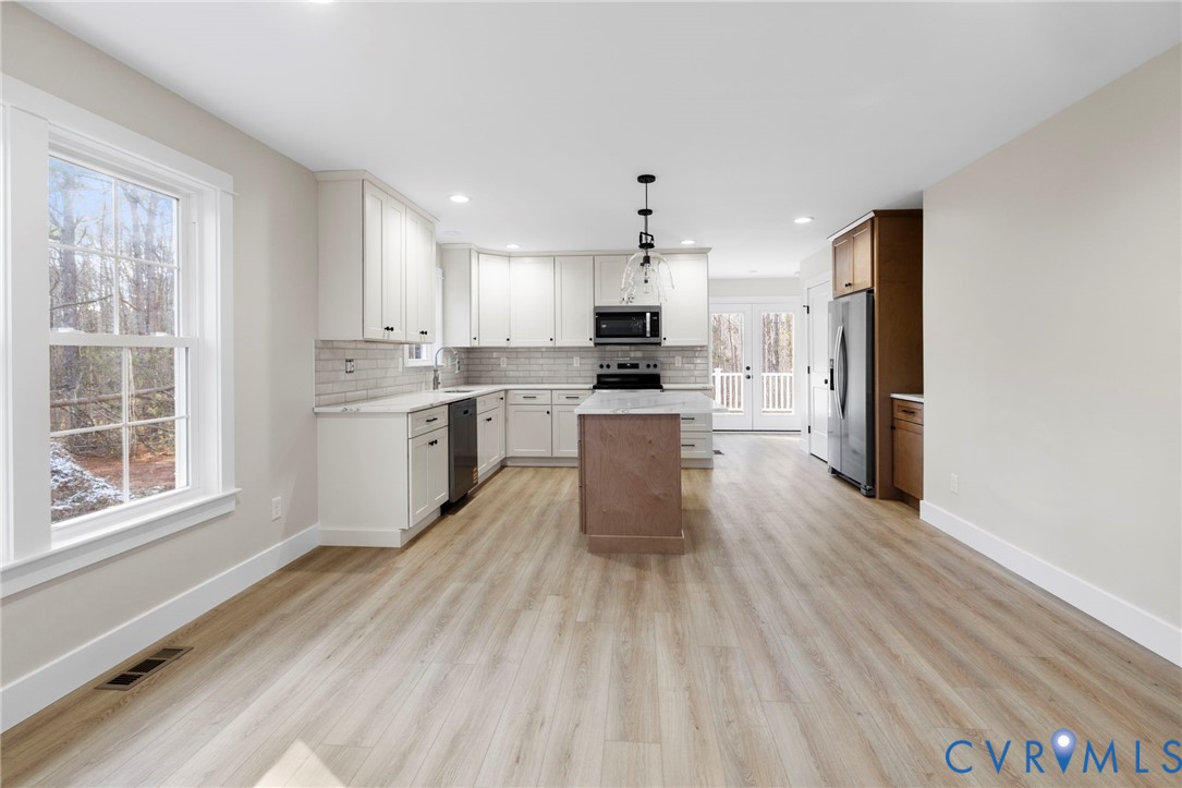 320 Vogel Road Cumberland, VA 23040 - Photo 9 of 28 a large kitchen with cabinets wooden floor and stainless steel appliances