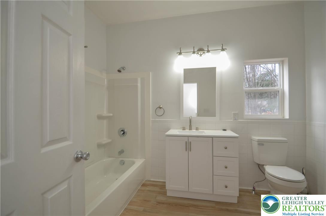 2 Elm Street Mount Pocono, PA 18344 - Photo 18 of 44 a spacious bathroom with a granite countertop sink toilet a large mirror a bathtub and shower