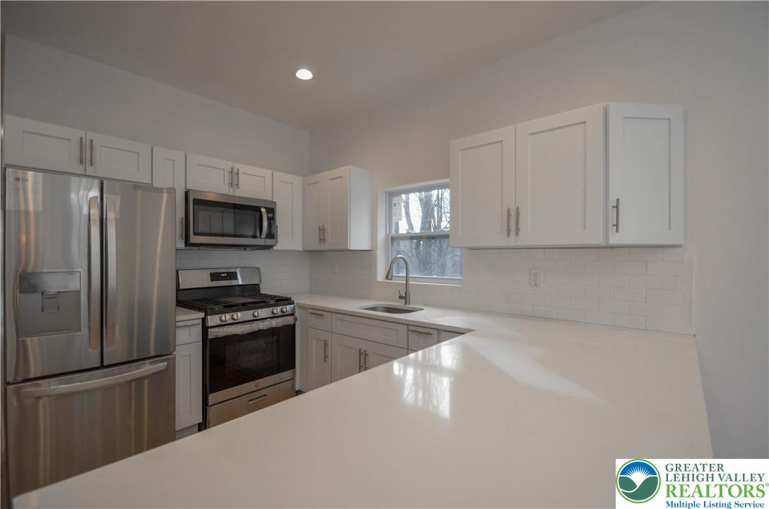 2 Elm Street Mount Pocono, PA 18344 - Photo 9 of 44 a kitchen with granite countertop a refrigerator stove and microwave