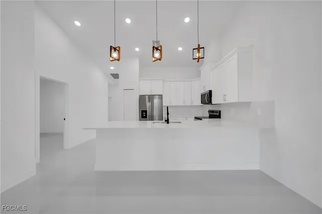 a view of a kitchen with a sink and a window