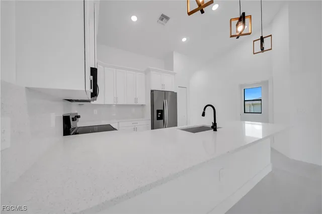a view of a kitchen with a sink and cabinets