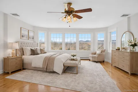 a spacious bedroom with a bed a couch and dresser