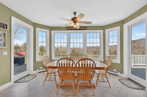 a view of a dining room with furniture wooden floor and a chandelier