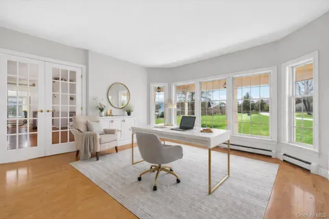 a living room with furniture and large windows