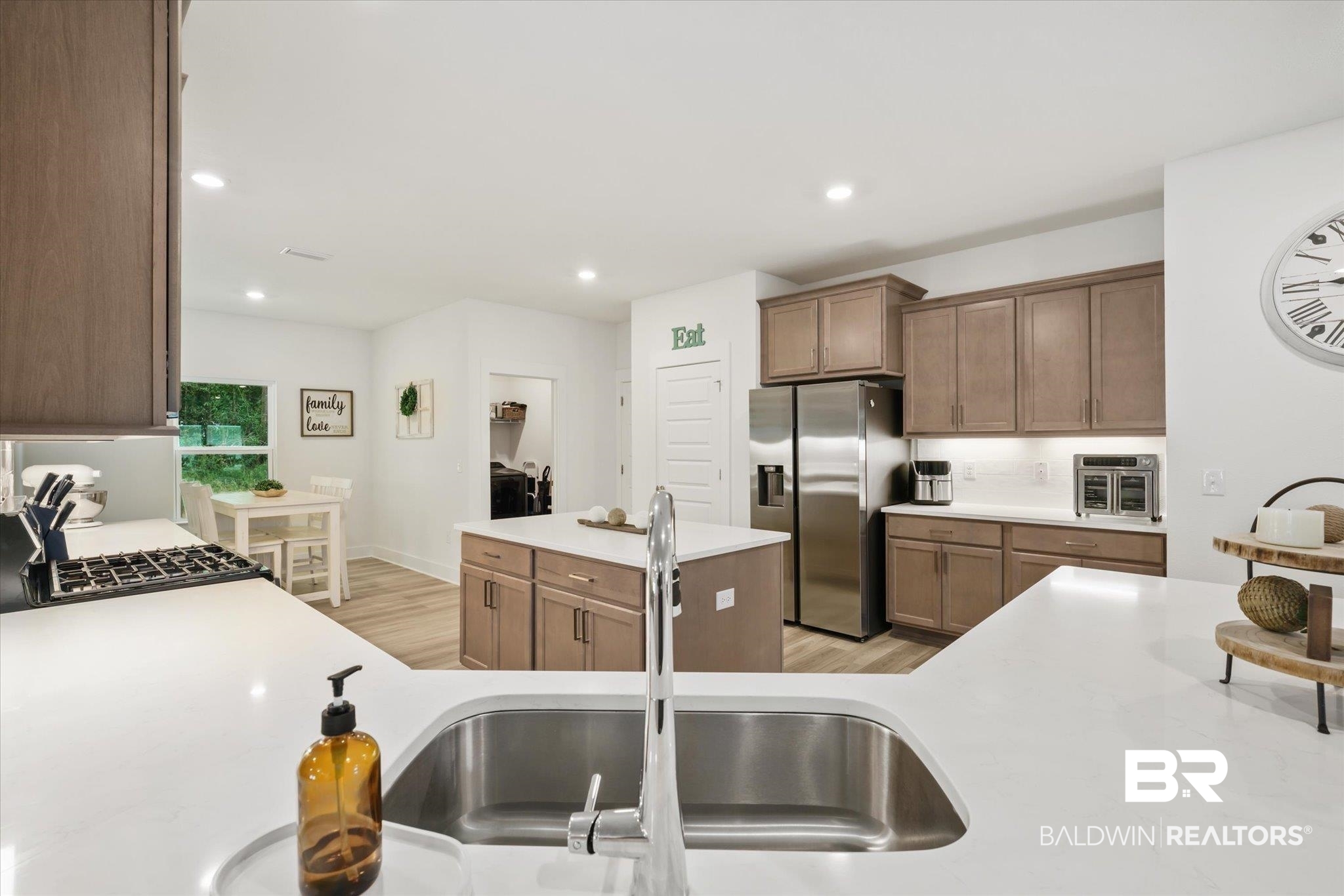 263 Bronze Street Fairhope, AL 36532 - Photo 6 of 47 Kitchen featuring a center island, light hardwood / wood-style floors, sink, and stainless steel refrigerator with ice dispenser