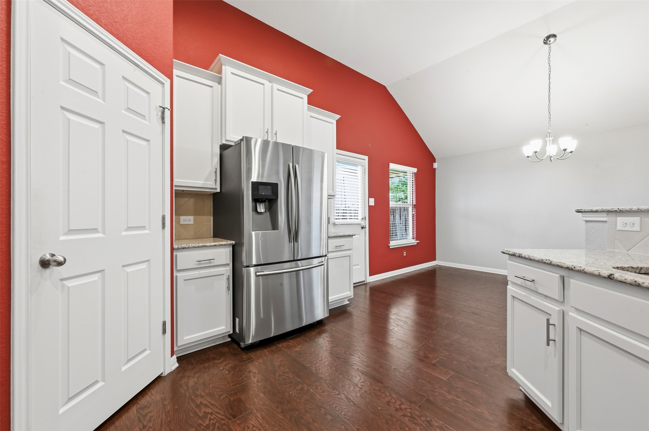 13116 Alans Way Manchaca, TX 78652 - Photo 12 of 25 Kitchen area featuring white cabinetry, stainless steel refrigerator, and wood-finish flooring