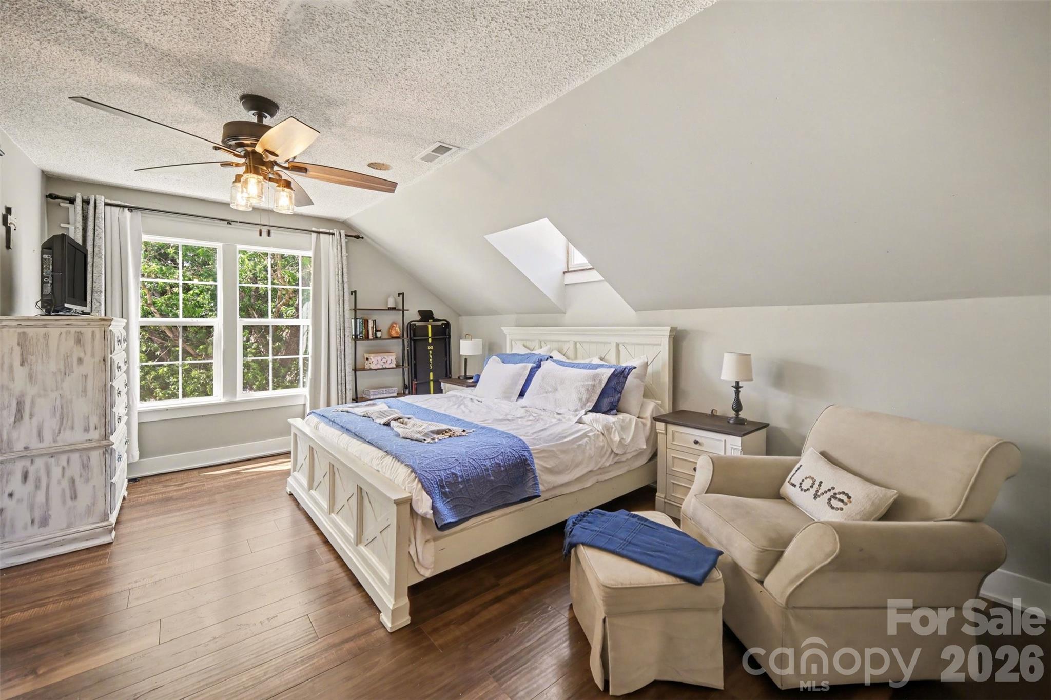 5226 Old Plank Road Iron Station, NC 28080 - Photo 17 of 45 a spacious bedroom with a bed and a chandelier