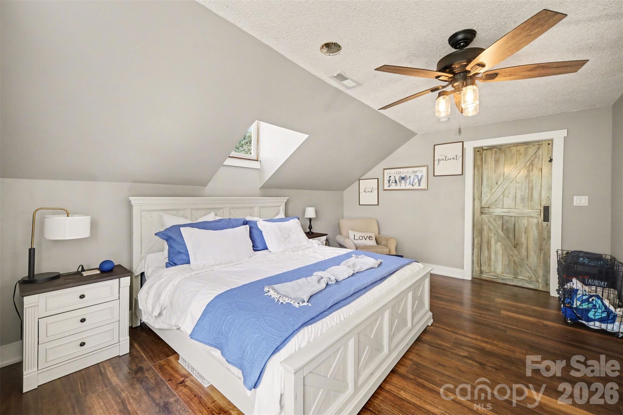 5226 Old Plank Road Iron Station, NC 28080 - Photo 18 of 45 a bedroom with a bed and a chandelier