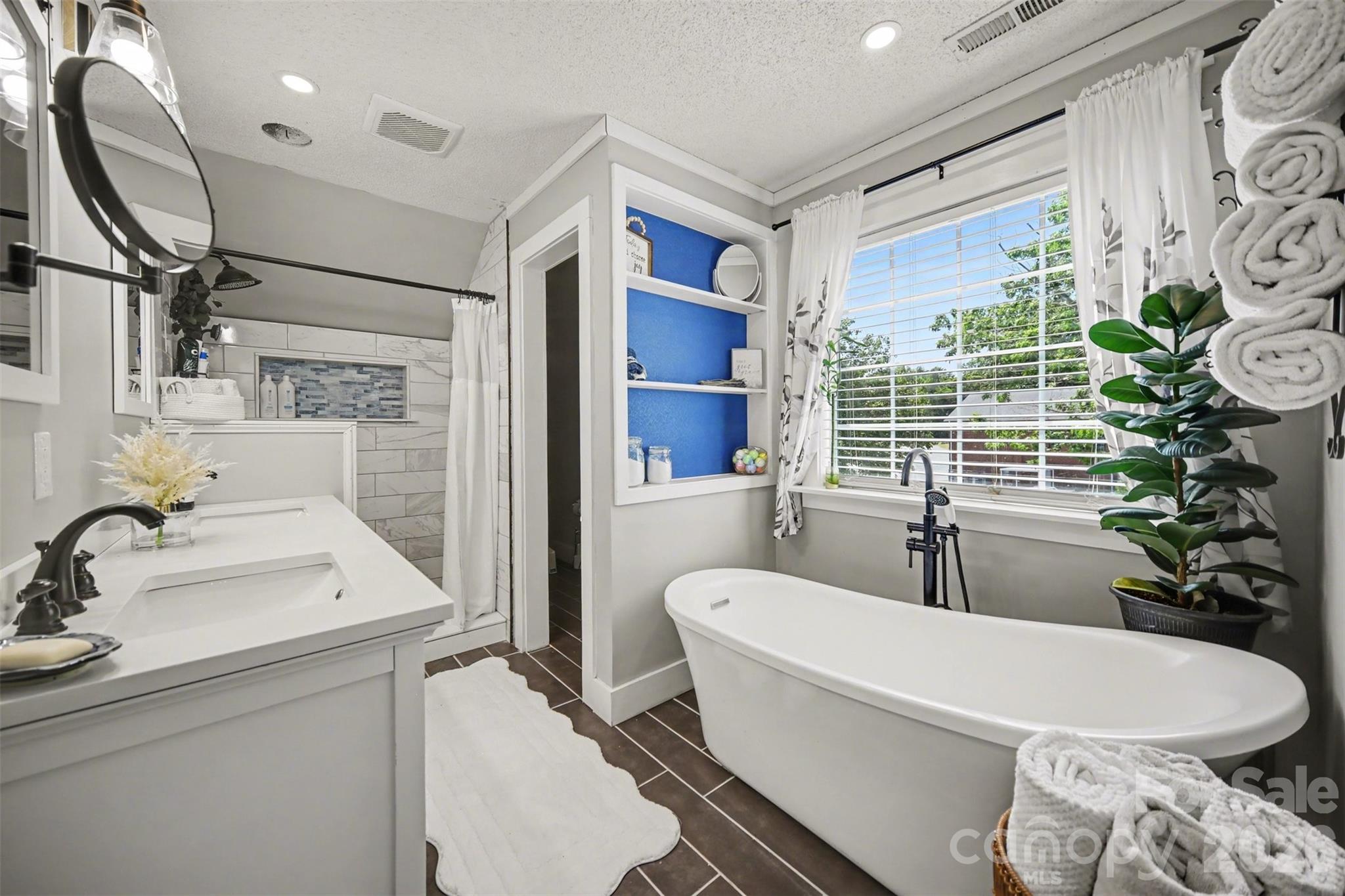 5226 Old Plank Road Iron Station, NC 28080 - Photo 19 of 45 a white bath tub sitting next to a white sink and cabinets