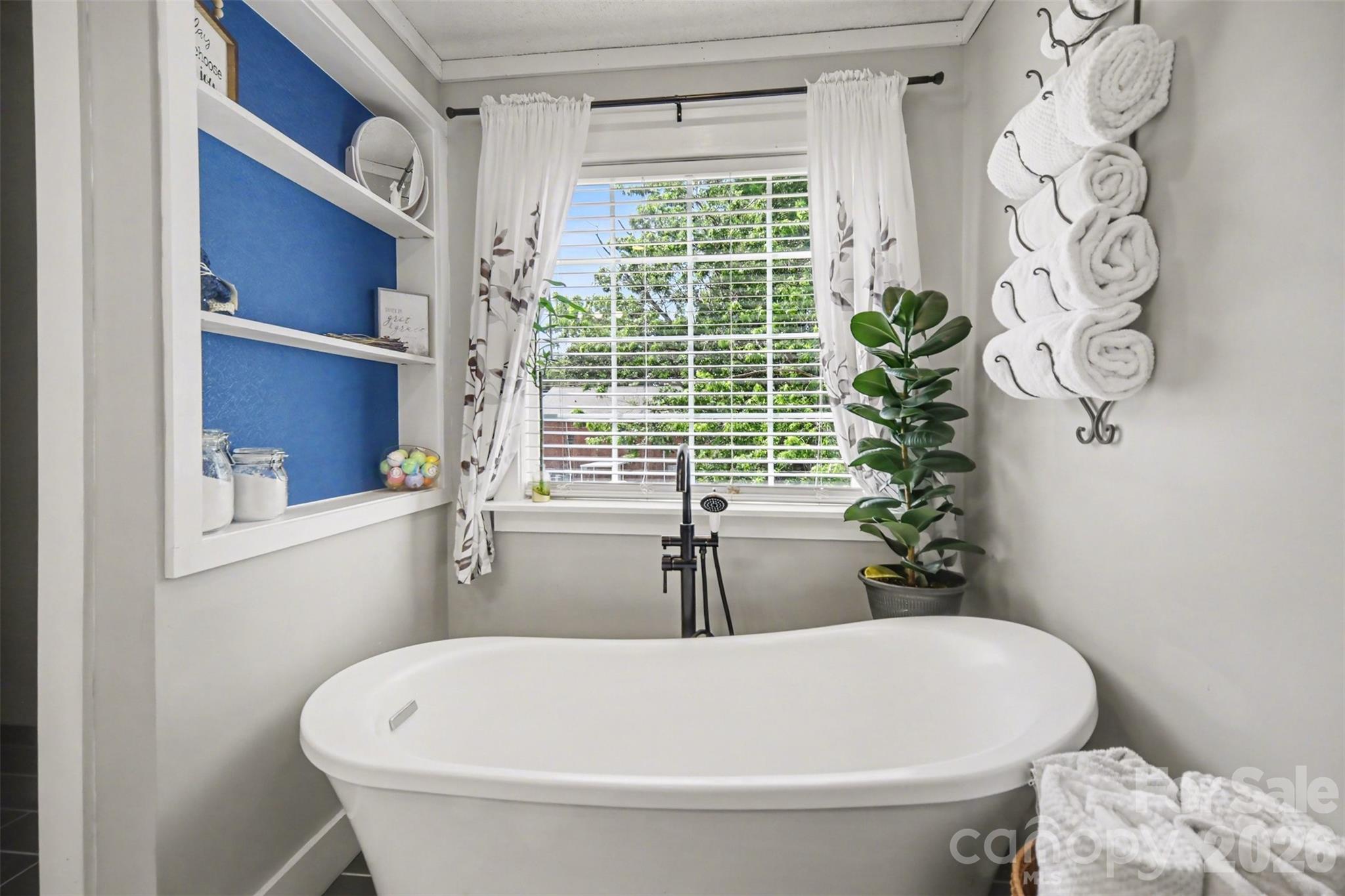 5226 Old Plank Road Iron Station, NC 28080 - Photo 21 of 45 a white bath tub sitting in a bathroom next to a window
