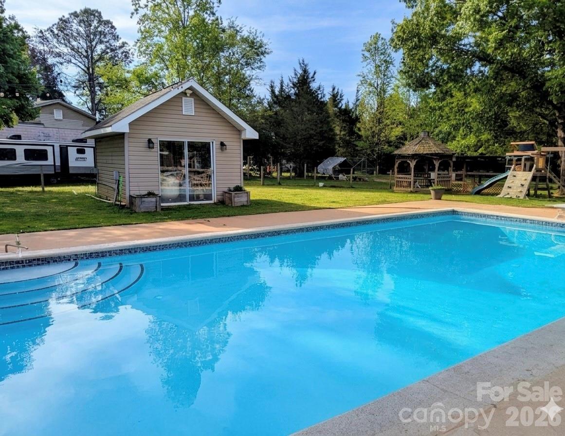 5226 Old Plank Road Iron Station, NC 28080 - Photo 32 of 45 a front view of a house with swimming pool