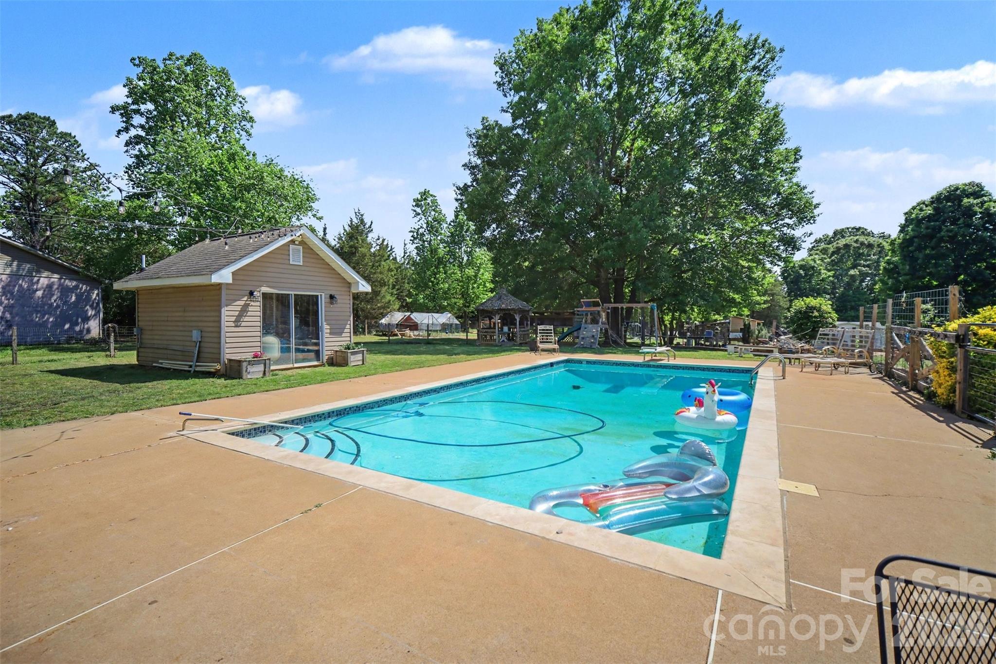 5226 Old Plank Road Iron Station, NC 28080 - Photo 35 of 45 a view of a house with swimming pool and yard