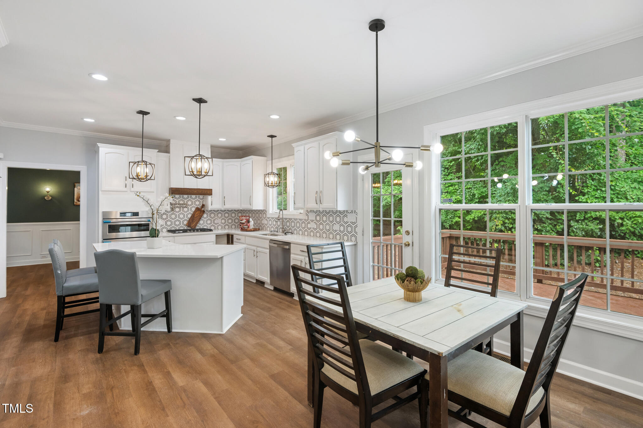 1604 Timber Wolf Drive Durham, NC 27713 - Photo 11 of 48 a view of a dining room and livingroom with furniture wooden floor a chandelier