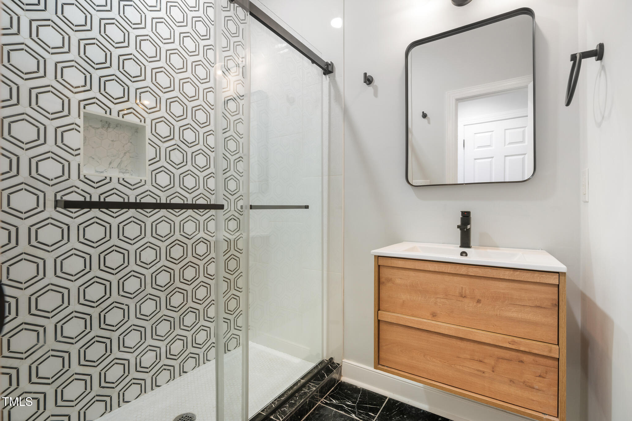 1604 Timber Wolf Drive Durham, NC 27713 - Photo 18 of 48 a bathroom with a sink and a mirror