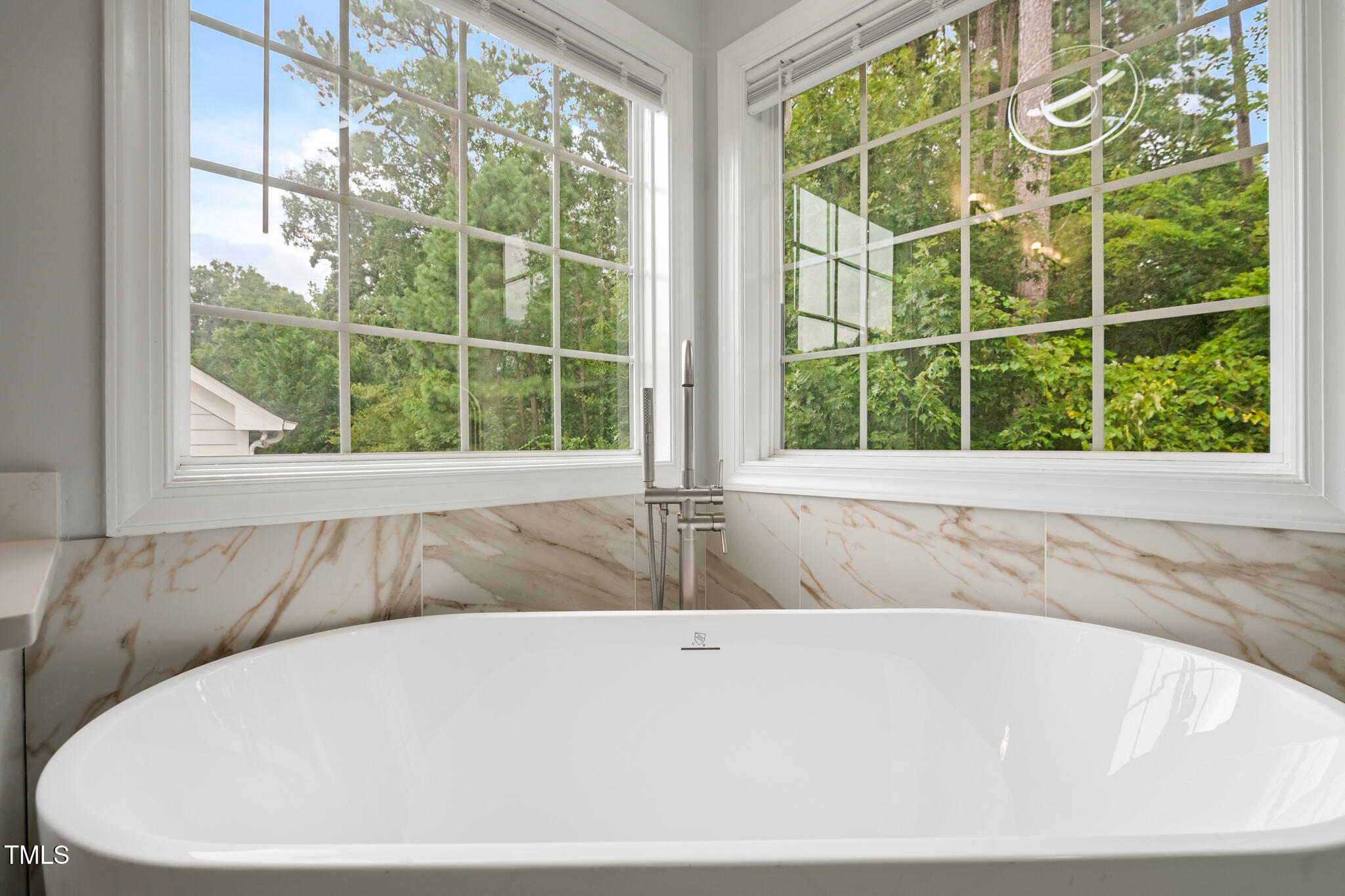 1604 Timber Wolf Drive Durham, NC 27713 - Photo 26 of 48 a white bath tub sitting in a bathroom next to a window