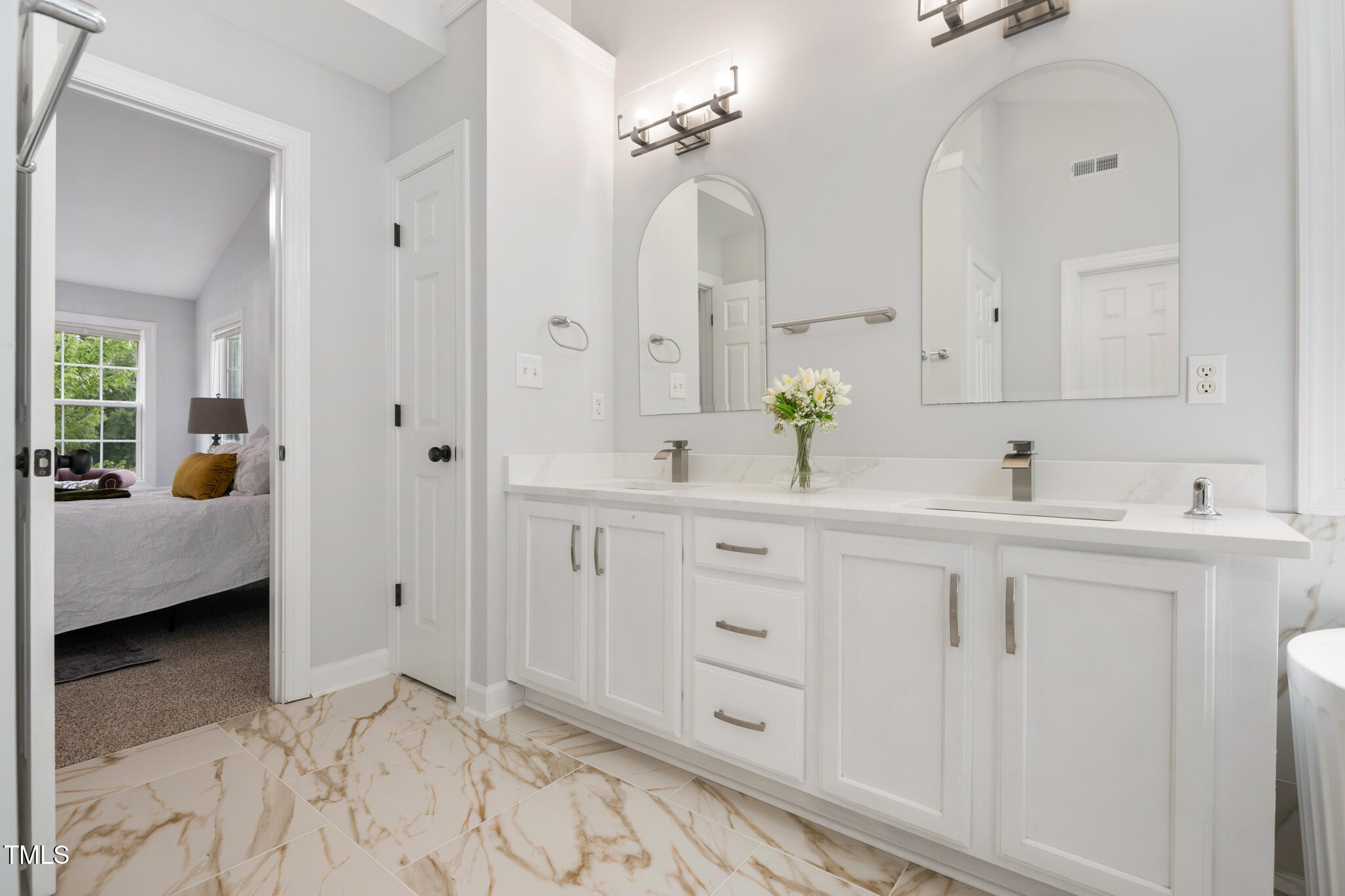 1604 Timber Wolf Drive Durham, NC 27713 - Photo 27 of 48 a spacious bathroom with double sink and a mirror