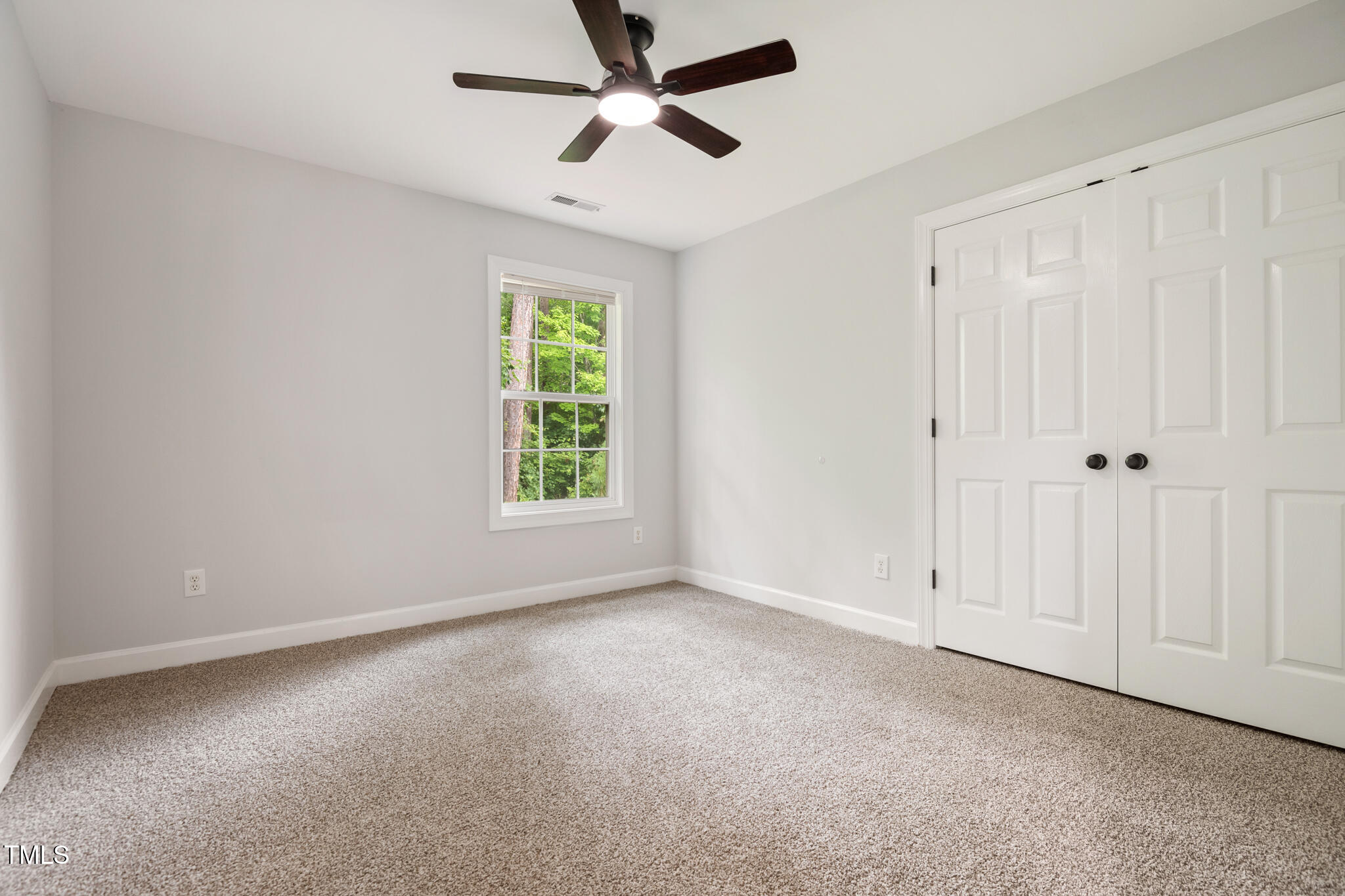 1604 Timber Wolf Drive Durham, NC 27713 - Photo 29 of 48 an empty room with windows and fan