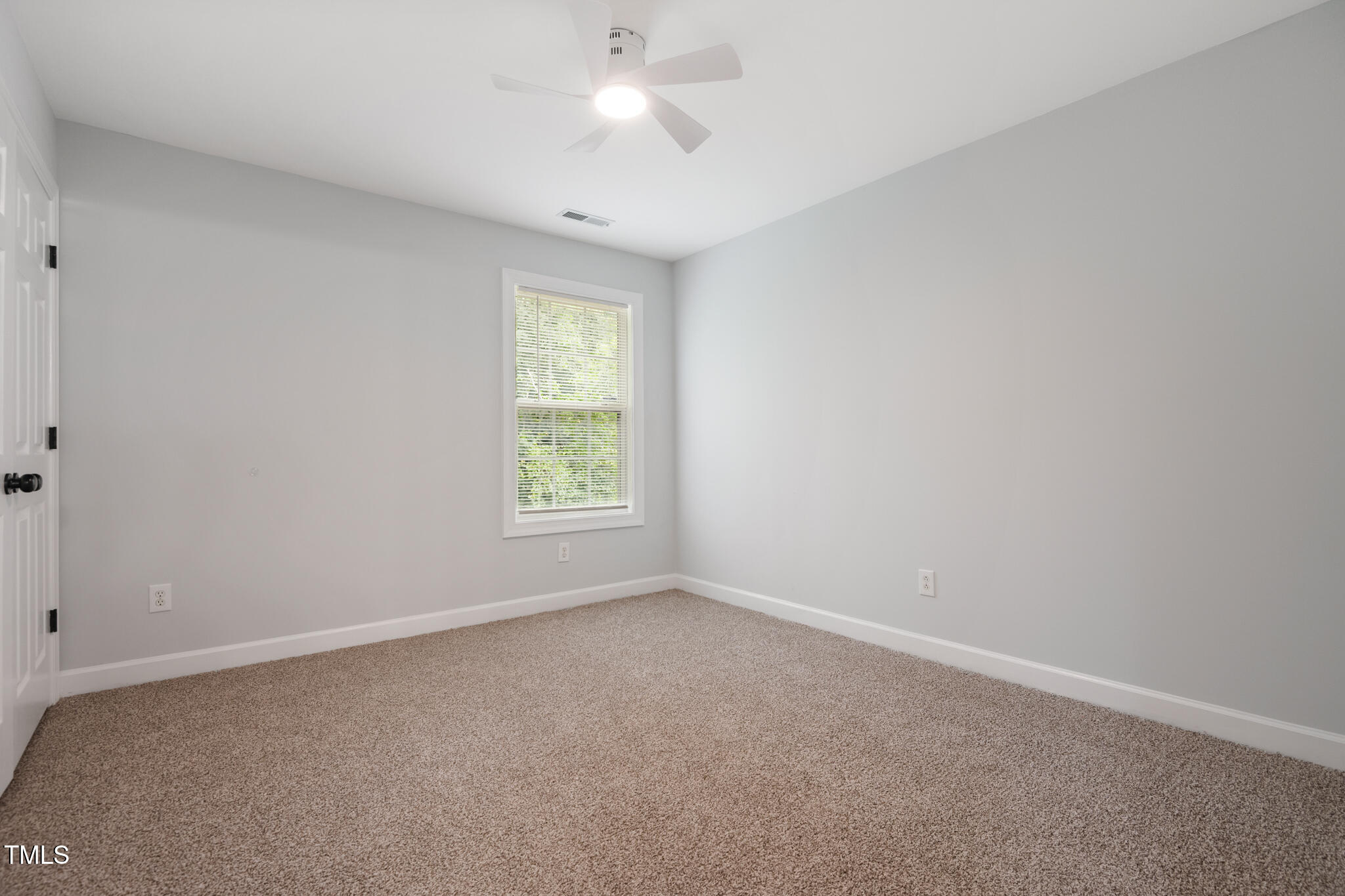 1604 Timber Wolf Drive Durham, NC 27713 - Photo 36 of 48 an empty room with a window and a fan