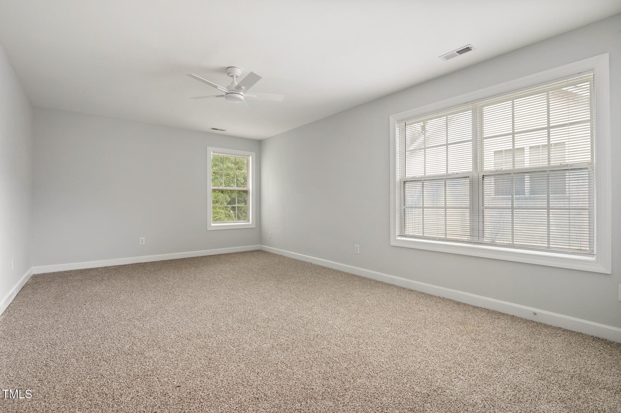 1604 Timber Wolf Drive Durham, NC 27713 - Photo 38 of 48 an empty room with a window and a ceiling fan