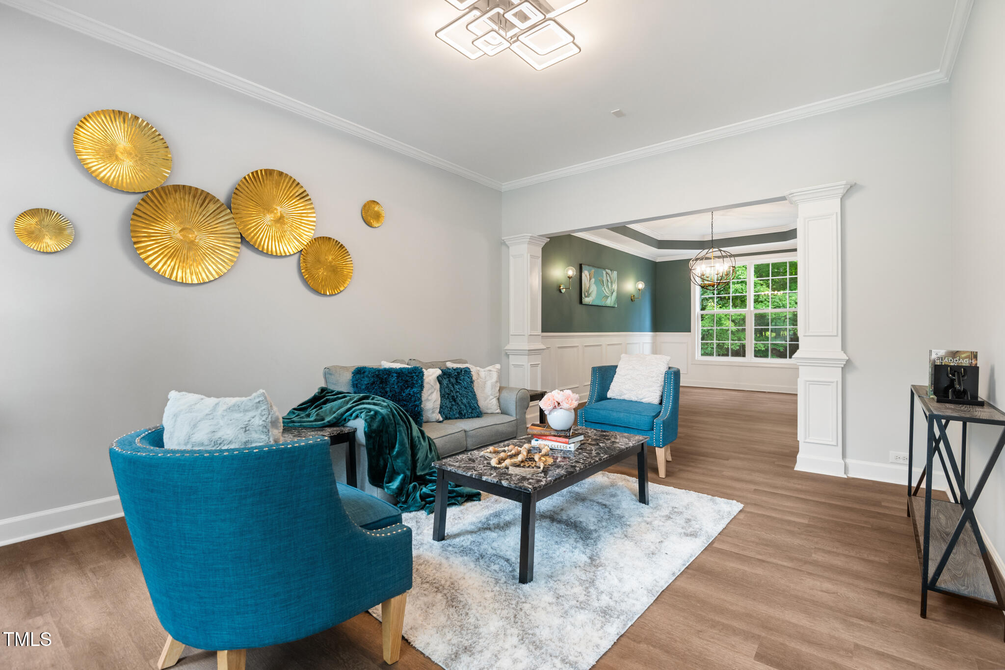 1604 Timber Wolf Drive Durham, NC 27713 - Photo 5 of 48 a living room with couches chair and a dining table with wooden floor