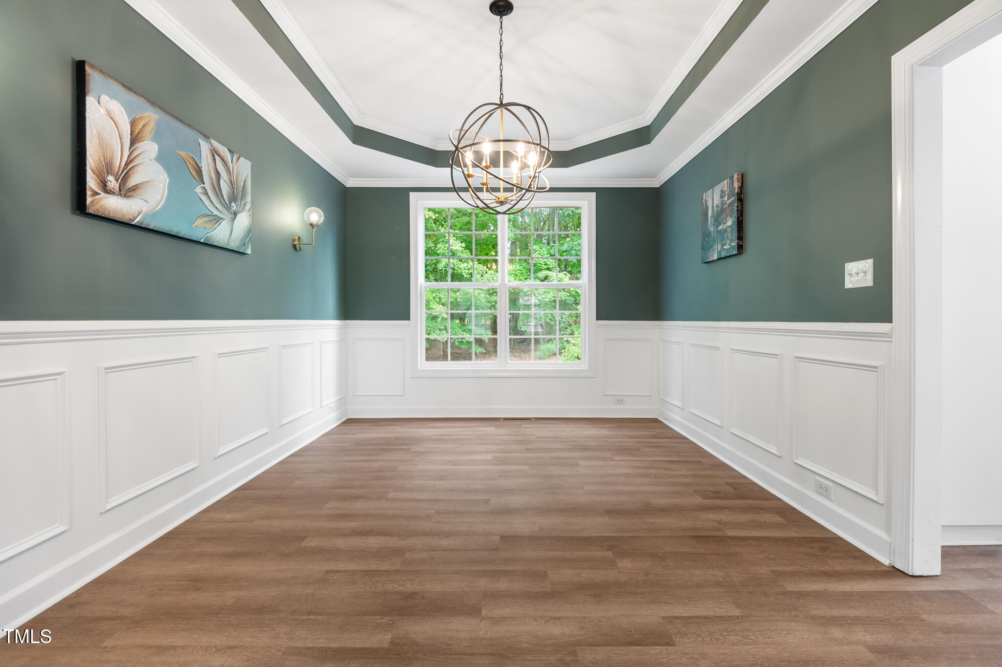 1604 Timber Wolf Drive Durham, NC 27713 - Photo 8 of 48 a view of an empty room with wooden floor and windows