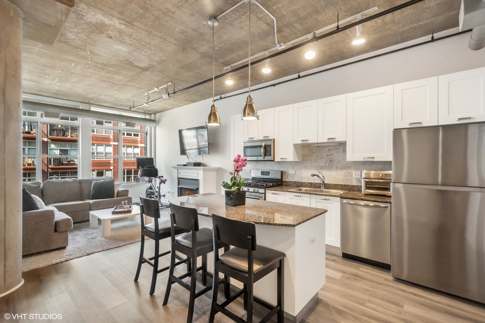 111 South Morgan Street, Unit 607 Chicago, IL 60607 - Photo 2 of 12 a kitchen with appliances a table and chairs in it