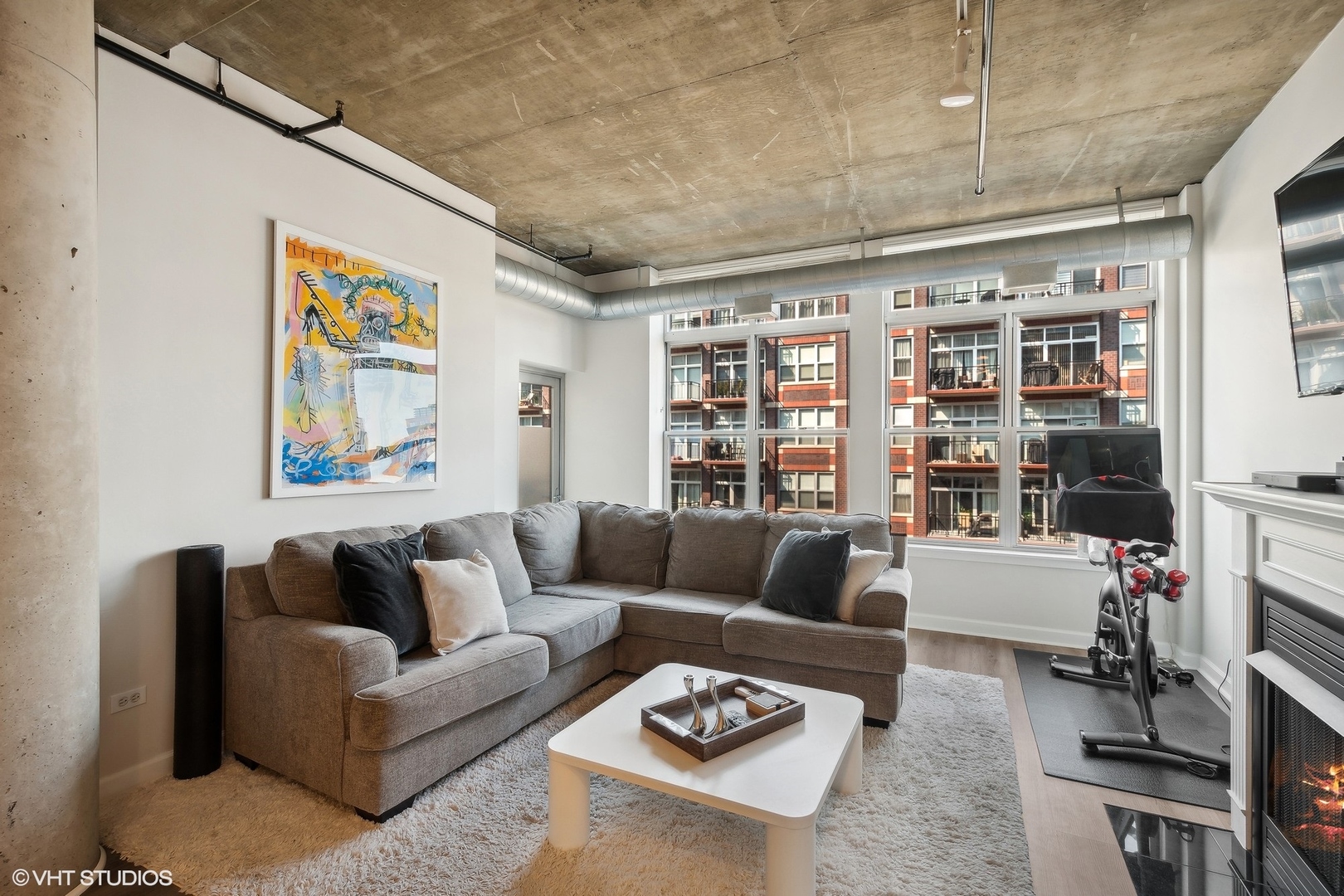 111 South Morgan Street, Unit 607 Chicago, IL 60607 - Photo 4 of 12 a living room with furniture a rug and a book shelf