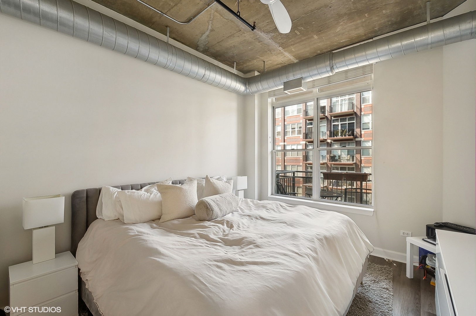 111 South Morgan Street, Unit 607 Chicago, IL 60607 - Photo 6 of 12 a bedroom with a bed and a window