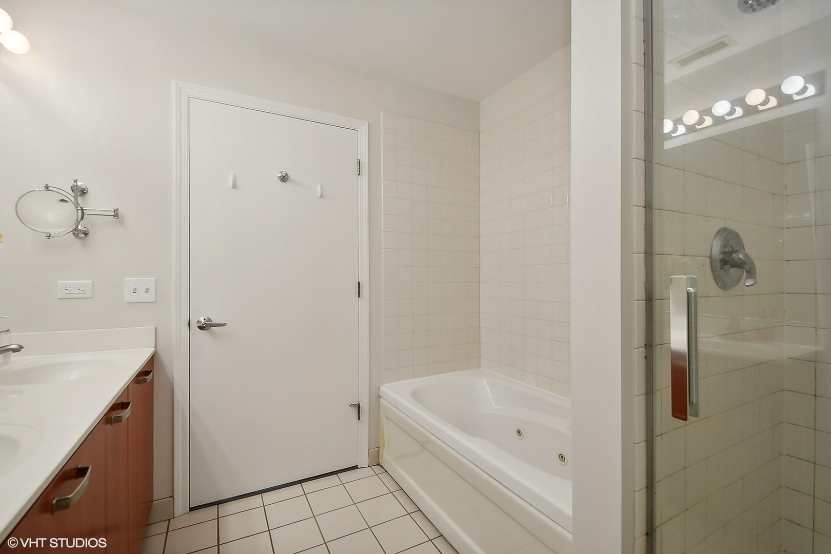 111 South Morgan Street, Unit 607 Chicago, IL 60607 - Photo 7 of 12 a bathroom with a bathtub a sink a vanity and a shower