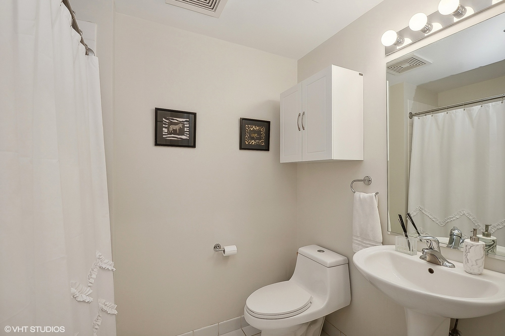 111 South Morgan Street, Unit 607 Chicago, IL 60607 - Photo 10 of 12 a bathroom with a toilet sink and mirror