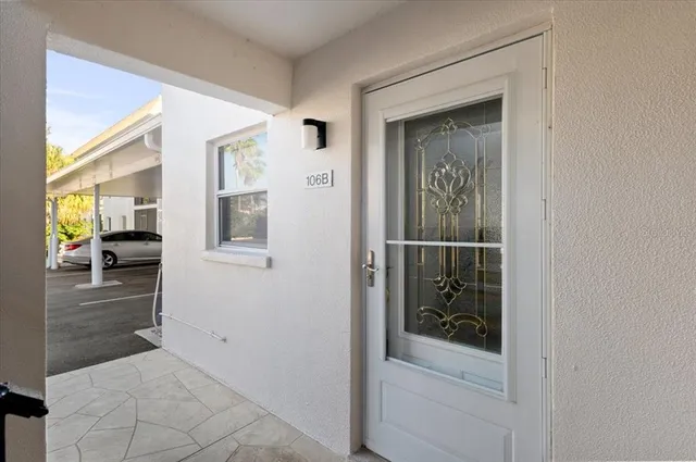 a view of a hallway with wooden floor and a living room