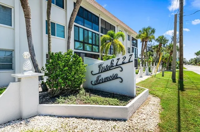 a view of a house with backyard porch and sitting area