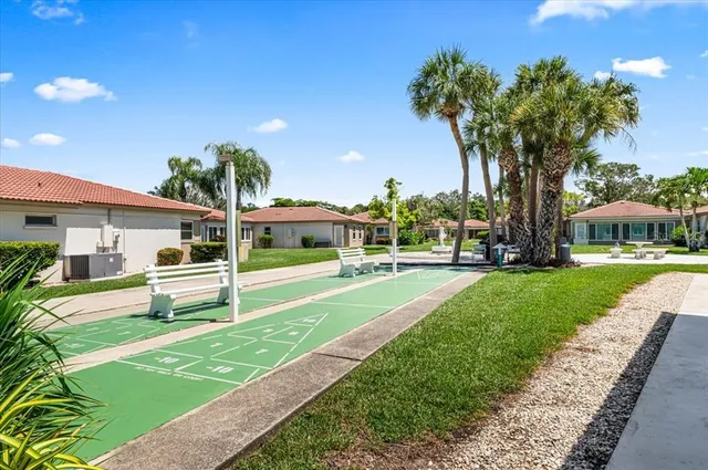 an aerial view of a residential houses with outdoor space and parking