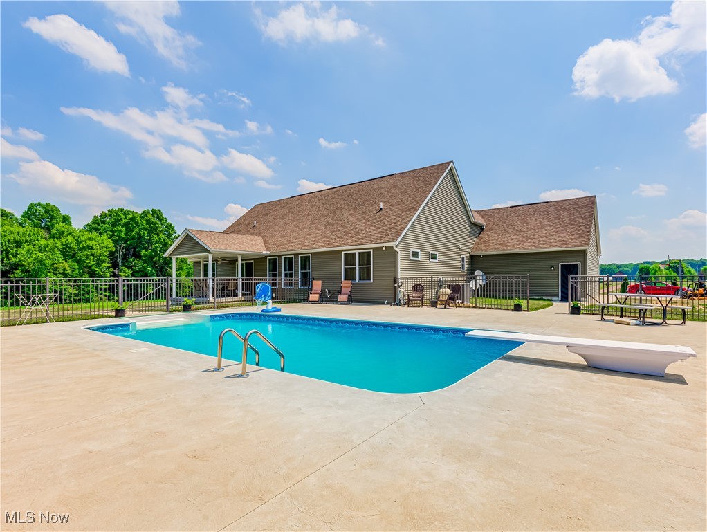 961 Industry Road Atwater, OH 44201 - Photo 3 of 50 View of swimming pool featuring a patio area and a diving board