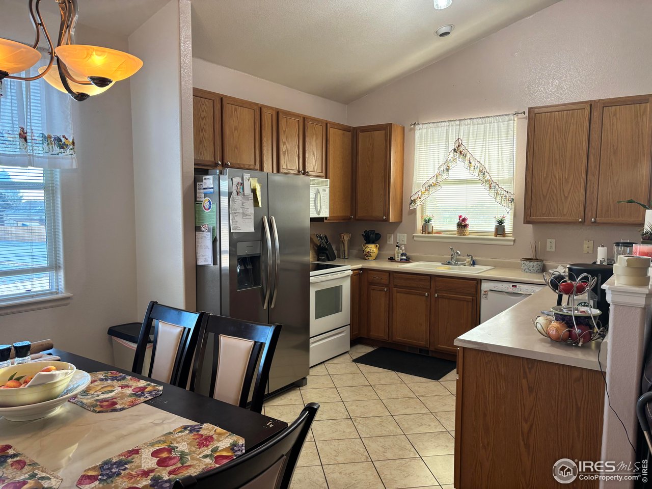 4902 29th Street, Unit 22D Greeley, CO 80634 - Photo 19 of 38 a kitchen with stainless steel appliances granite countertop a refrigerator sink and stove