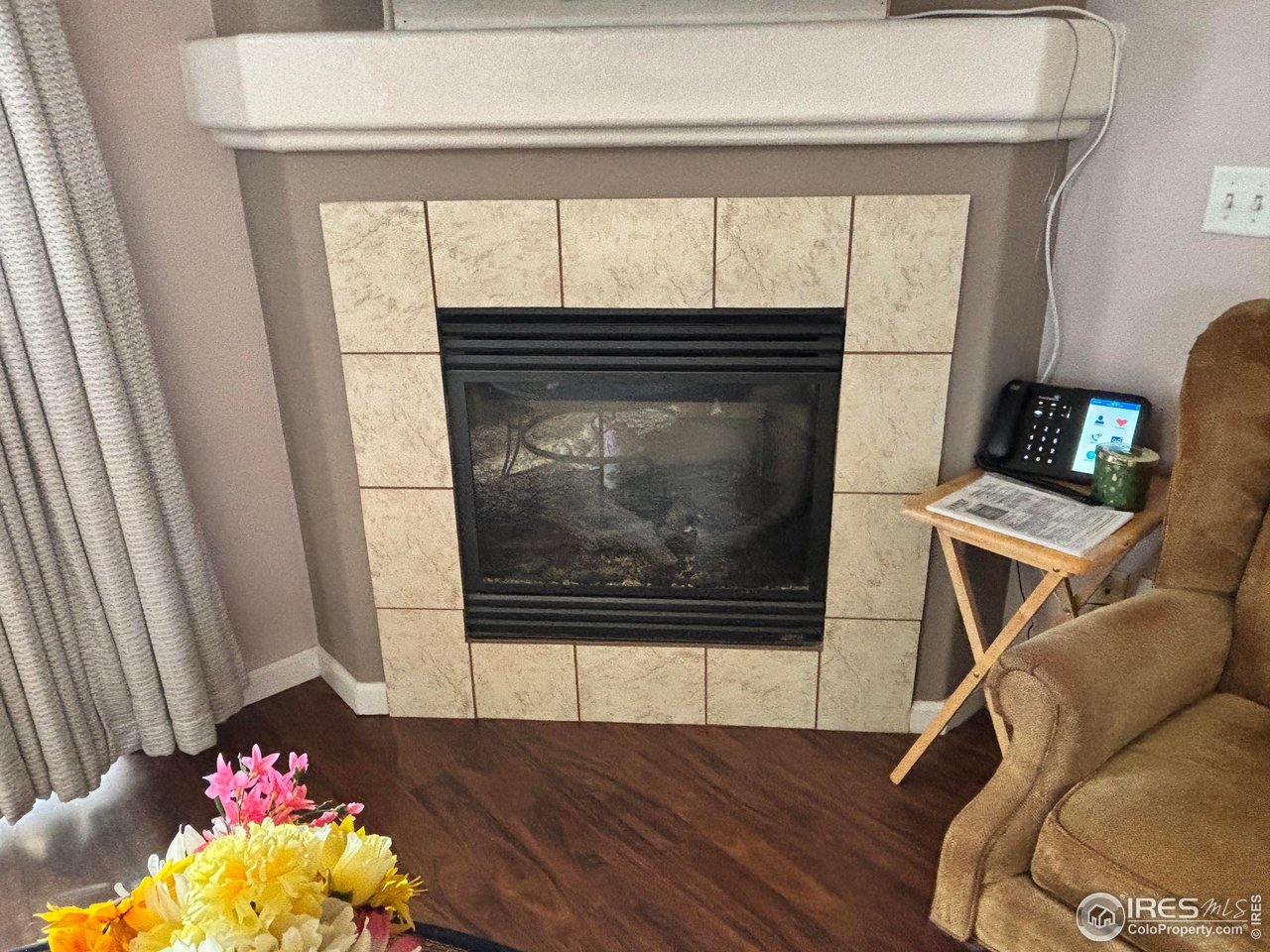 4902 29th Street, Unit 22D Greeley, CO 80634 - Photo 8 of 38 a living room with a fireplace and a floor to ceiling window