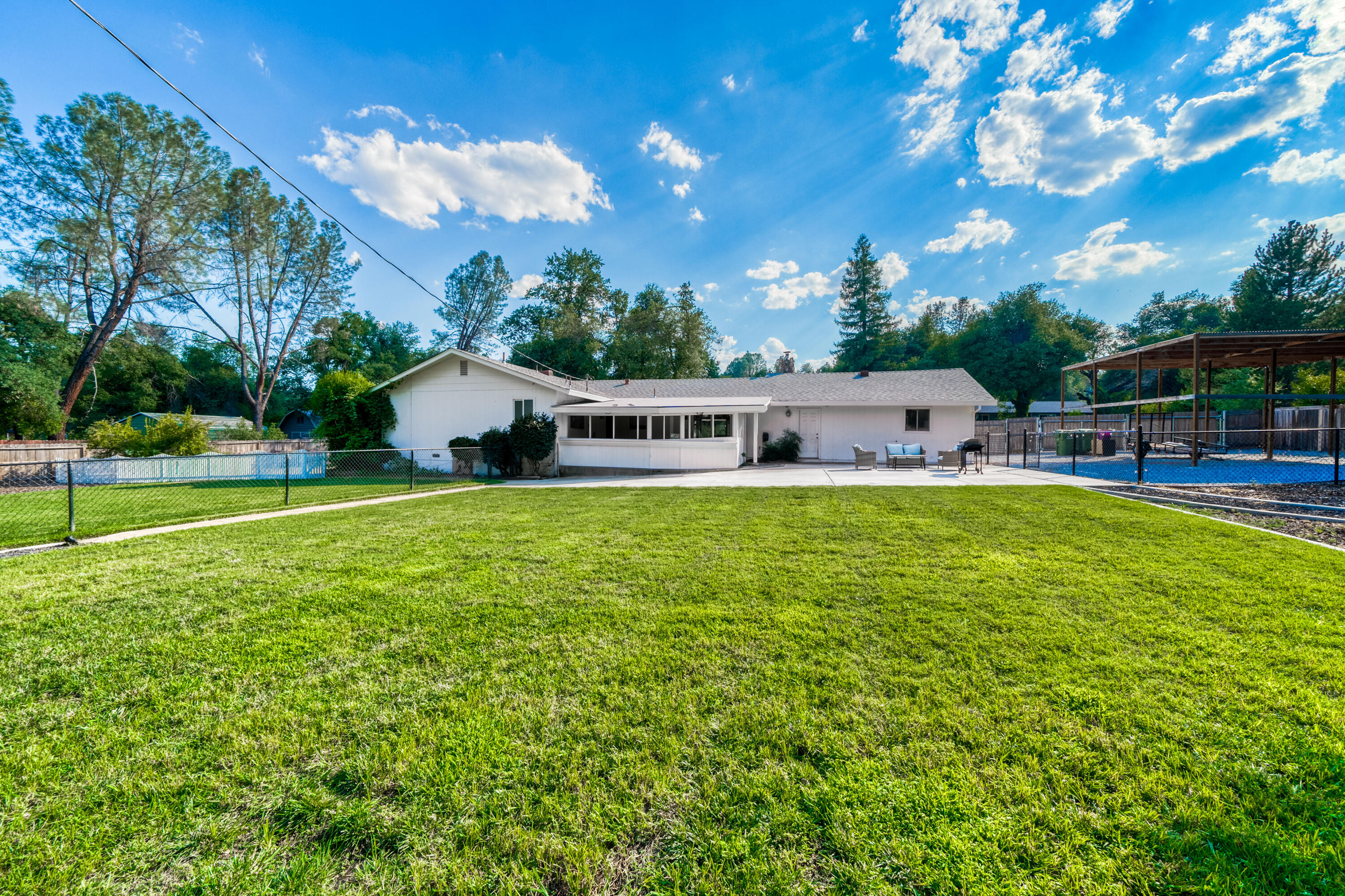8631 Prospectors Road Redding, CA 96001 - Photo 41 of 41 a house view with swimming pool and trees in the background