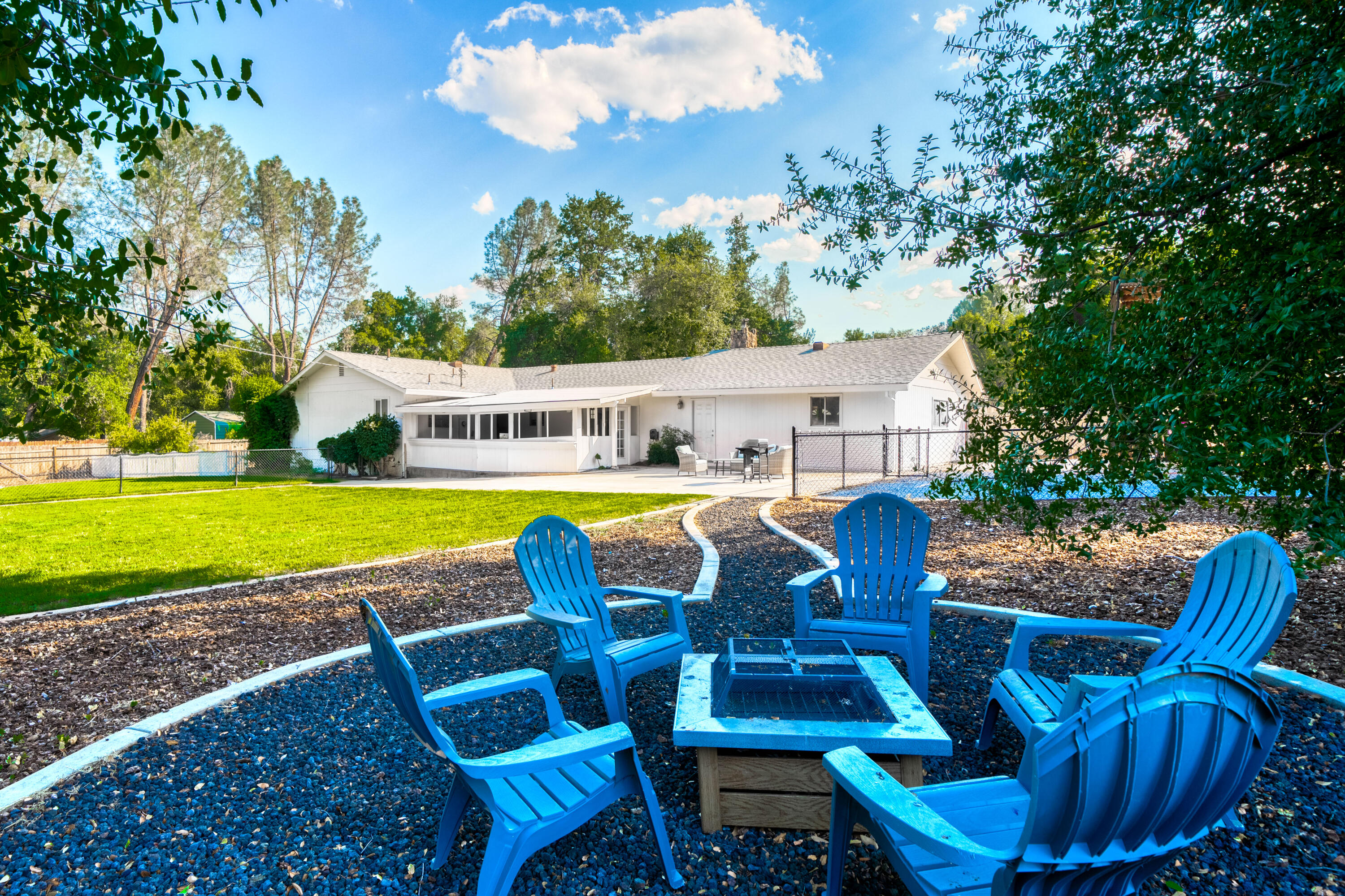 8631 Prospectors Road Redding, CA 96001 - Photo 7 of 41 a view of a swimming pool with lawn chairs under an umbrella