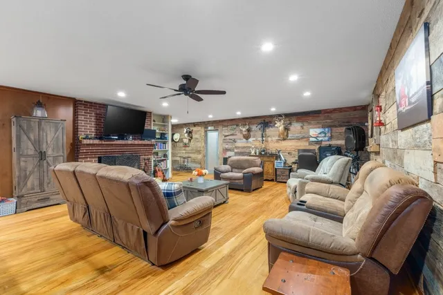 a view of kitchen with oven a refrigerator and chairs