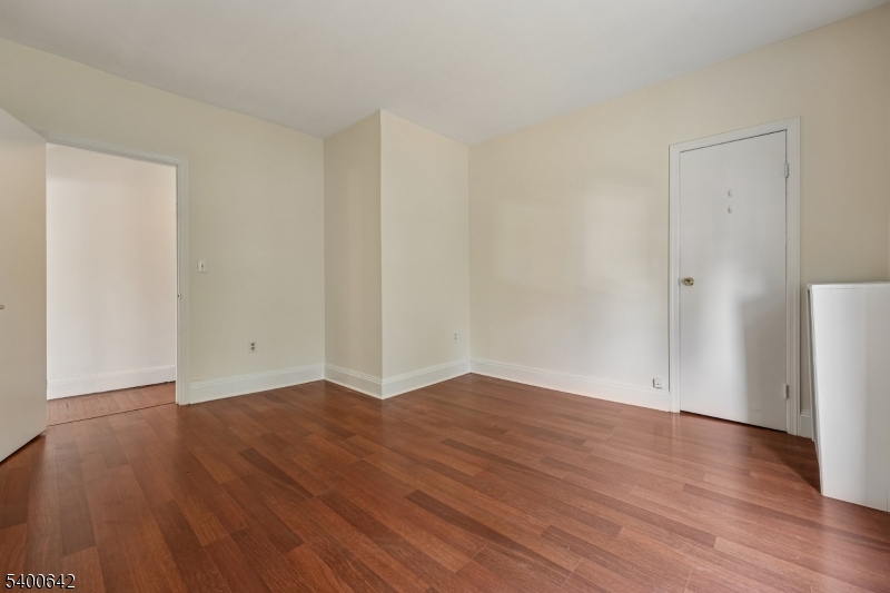 24 Franklin Place Summit, NJ 07901 - Photo 17 of 36 a view of an empty room with wooden floor and a window