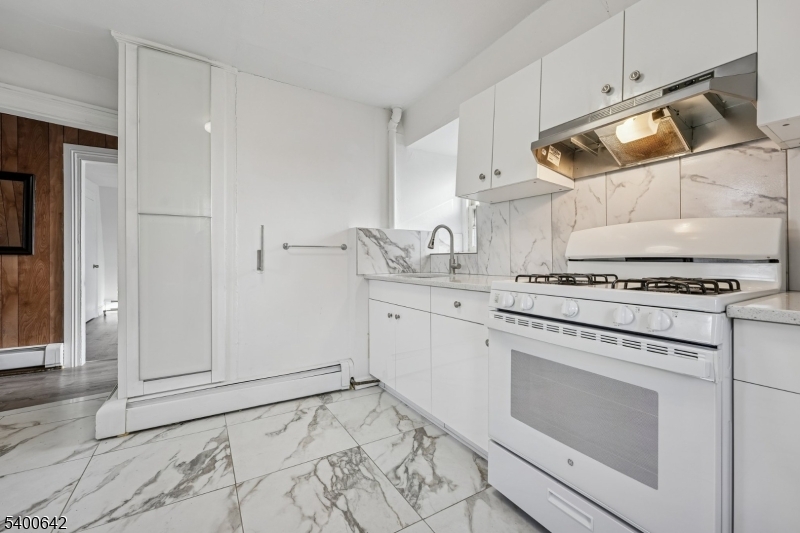 24 Franklin Place Summit, NJ 07901 - Photo 20 of 36 a kitchen with white cabinets and appliances