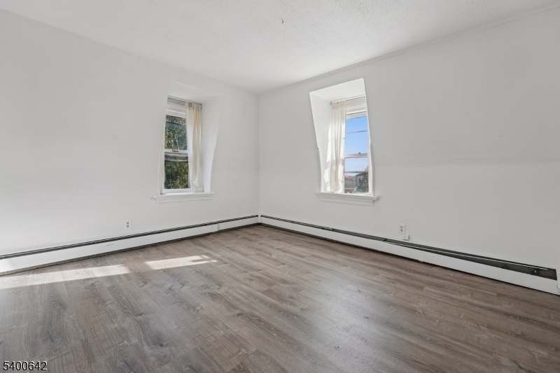 24 Franklin Place Summit, NJ 07901 - Photo 21 of 36 an empty room with wooden floor and windows