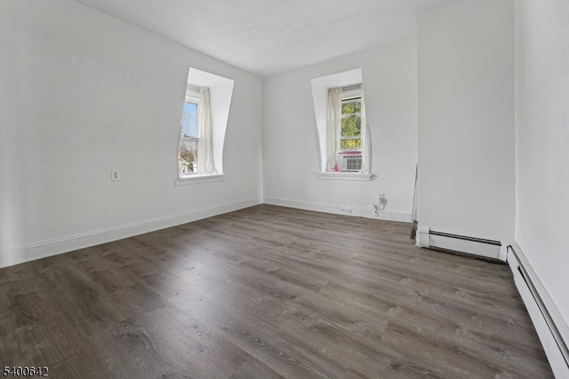 24 Franklin Place Summit, NJ 07901 - Photo 24 of 36 an empty room with wooden floor and windows