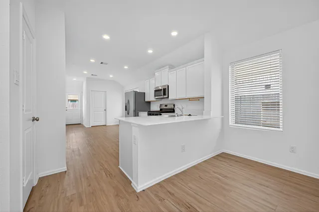a view of kitchen with wooden floor